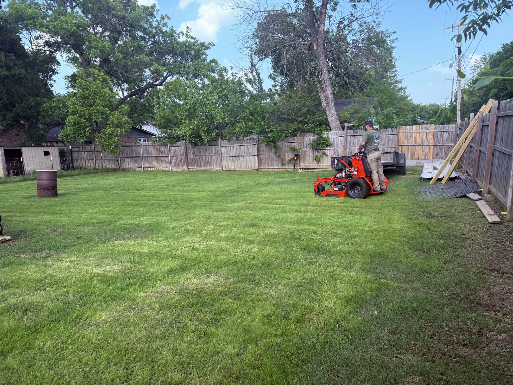 Revolution Lawn Care mowing a residential property